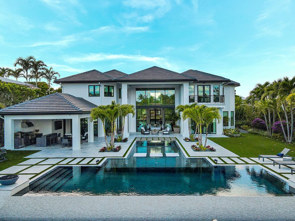 Elegant pool deck with natural stone tiles from Stoneline Group.