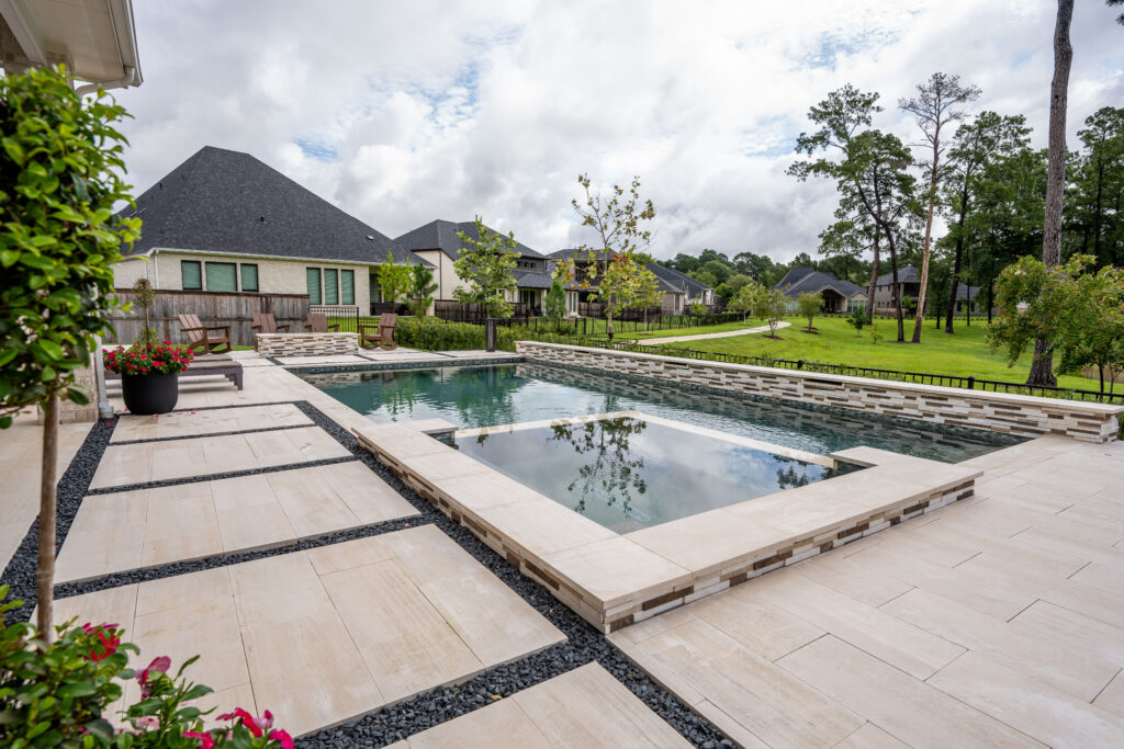 Elegant pool deck with natural stone tiles from Stoneline Group.