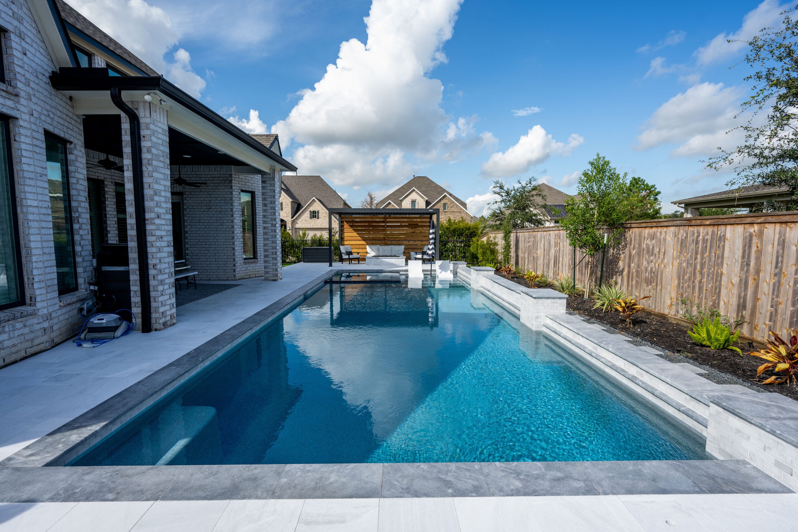 Elegant patio with a stone fire pit, perfect for outdoor relaxation and gatherings.