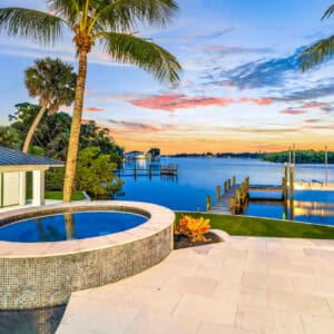 Monaco Sand paver stone tiles around a luxury swimming pool, natural stone pool deck design