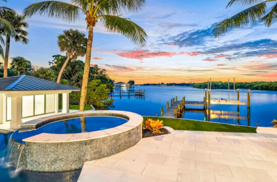 Monaco Sand paver stone tiles around a luxury swimming pool, natural stone pool deck design