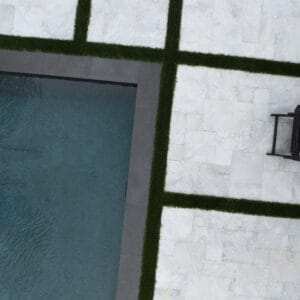 White Mist sandblasted marble pavers surrounding a modern swimming pool
